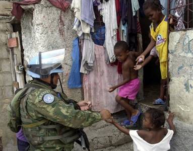 Un soldat de la Minustah le 20 juin 2009 avec des enfants à Haïti